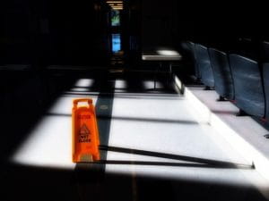 Signalisation de sol glissant dans un hall.
